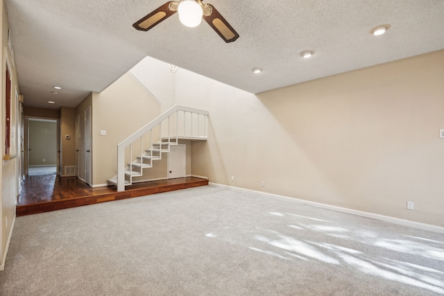 9728 Amberton Pkwy, Dallas, TX 75243 - unfurnished living room with stairs, ceiling fan, a textured ceiling, carpet, and baseboards