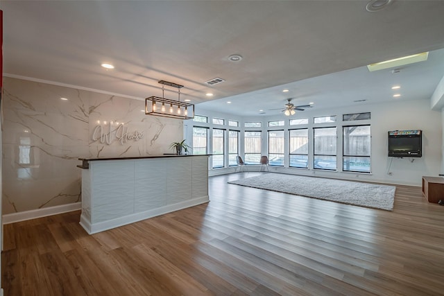 interior space with ceiling fan