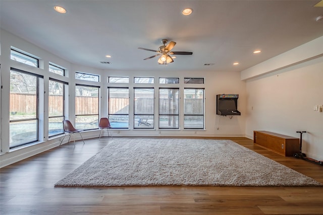 unfurnished living room with dark hardwood / wood-style floors and ceiling fan