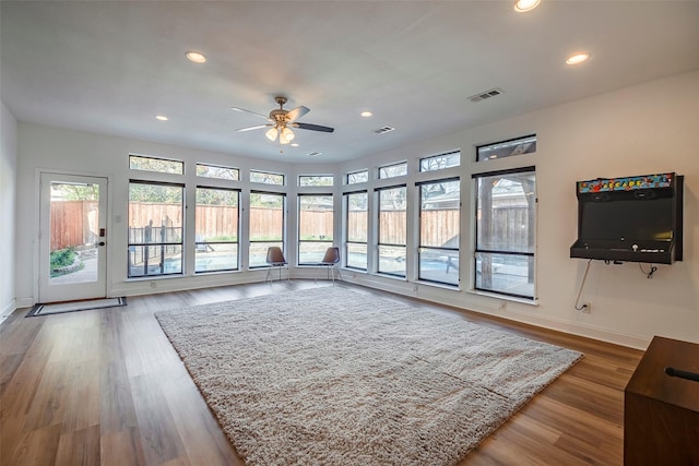 living room featuring hardwood / wood-style flooring and ceiling fan