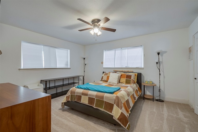 bedroom featuring ceiling fan and light carpet