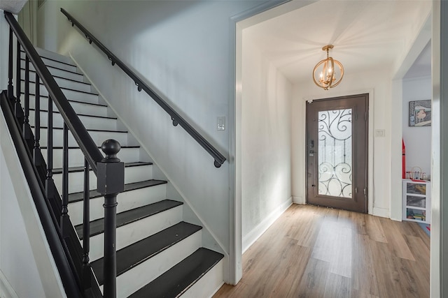 entrance foyer featuring light hardwood / wood-style flooring and a chandelier