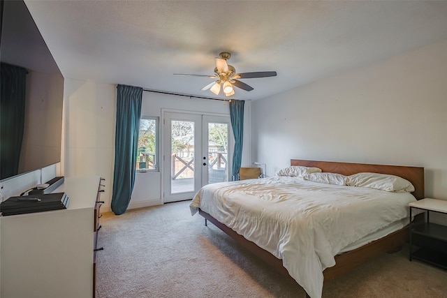 bedroom with access to exterior, french doors, light colored carpet, and ceiling fan