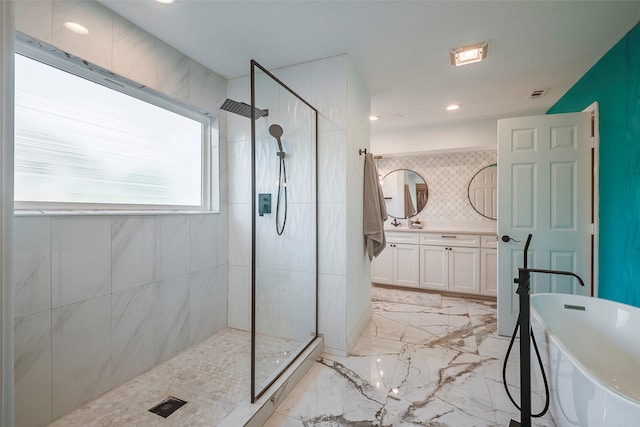 bathroom with vanity, decorative backsplash, and plus walk in shower