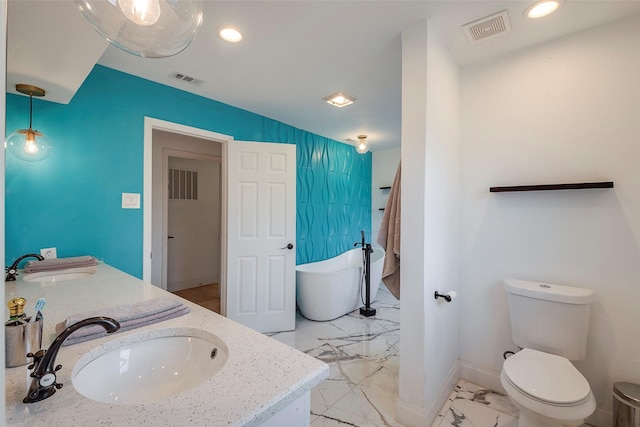 bathroom with vanity, toilet, and a tub