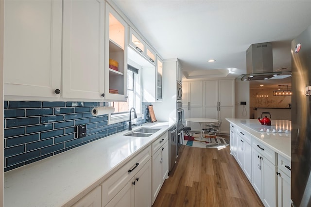 kitchen featuring light hardwood / wood-style flooring, white cabinetry, and sink