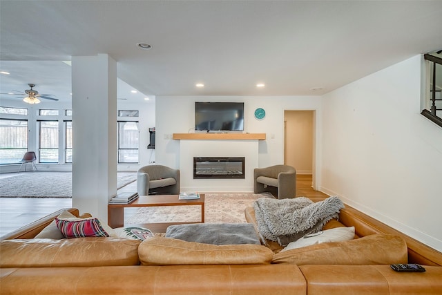 living room with ceiling fan and hardwood / wood-style floors