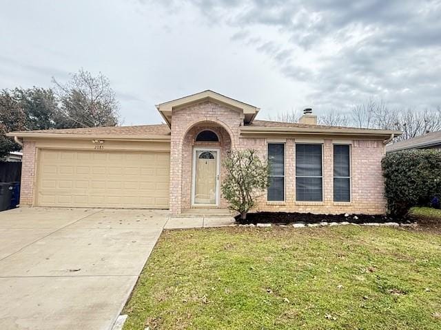 ranch-style home with a front lawn and a garage