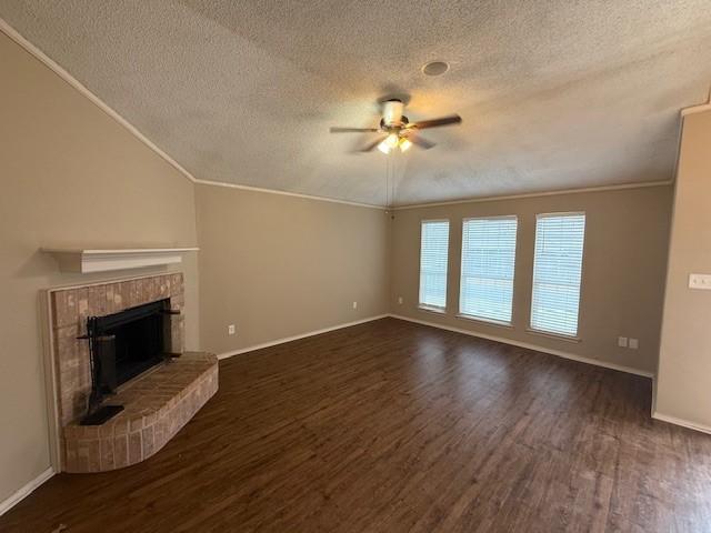 unfurnished living room featuring ceiling fan, crown molding, dark hardwood / wood-style flooring, and lofted ceiling