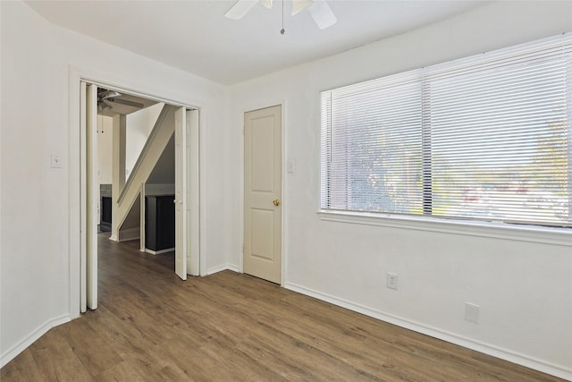 spare room with ceiling fan and dark hardwood / wood-style flooring