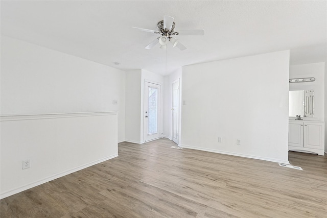 unfurnished room featuring ceiling fan and light hardwood / wood-style floors