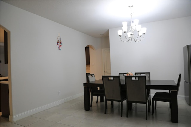 tiled dining room featuring a notable chandelier