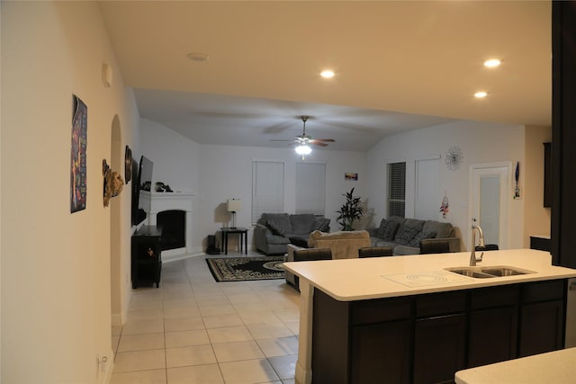 kitchen featuring ceiling fan, sink, and light tile patterned flooring