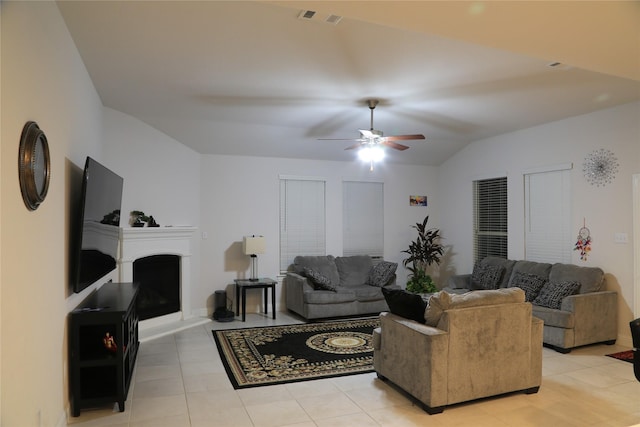 tiled living room featuring ceiling fan and lofted ceiling