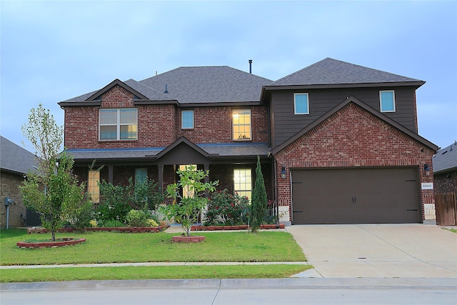 view of front of home with a front lawn and a garage