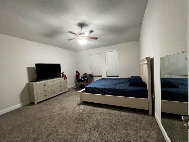 carpeted bedroom with ceiling fan and a textured ceiling