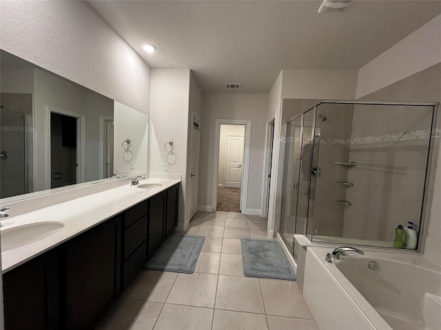 bathroom with tile patterned flooring, shower with separate bathtub, and vanity