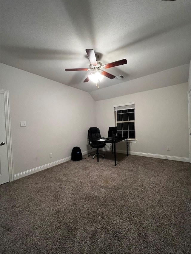 unfurnished office featuring ceiling fan, dark carpet, and lofted ceiling