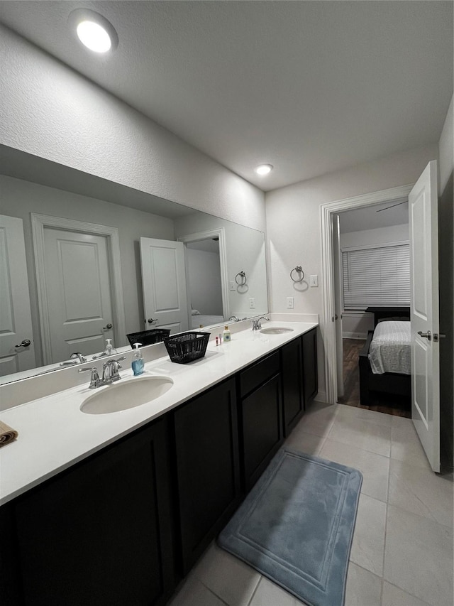 bathroom with tile patterned flooring and vanity