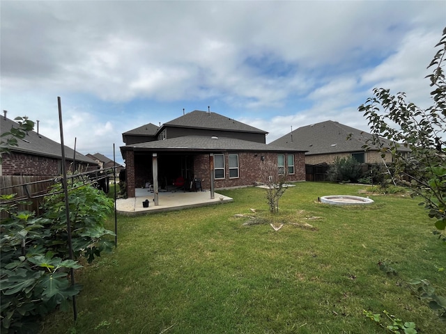 rear view of property with a patio area and a yard