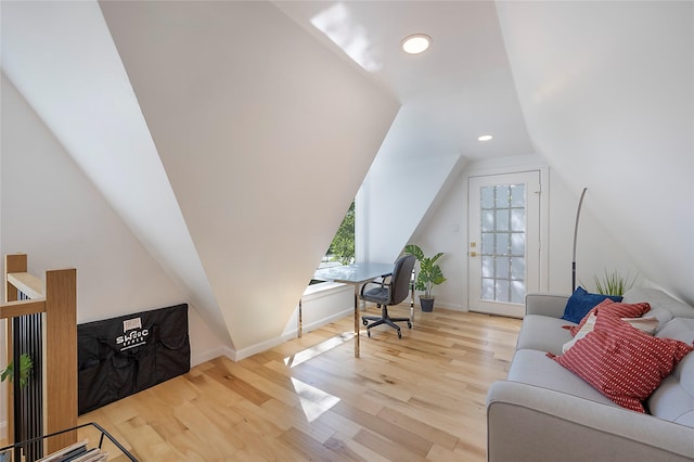 office area with light hardwood / wood-style floors and vaulted ceiling