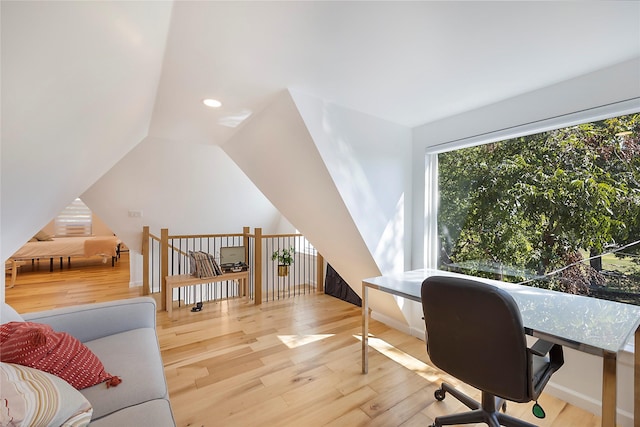 office with wood-type flooring and lofted ceiling