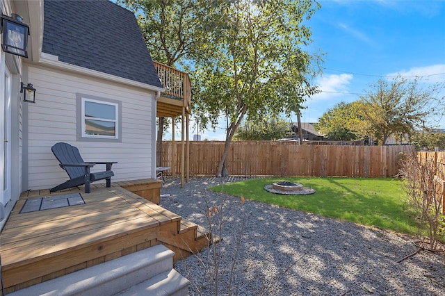 view of yard featuring a fire pit and a deck