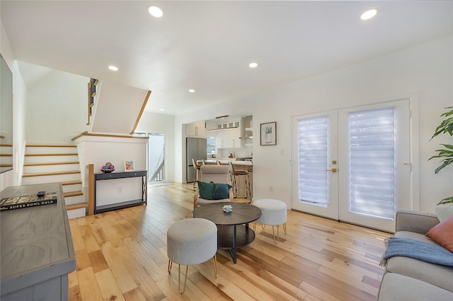 living room with light hardwood / wood-style flooring and french doors