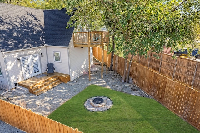 exterior space with a fire pit and a wooden deck