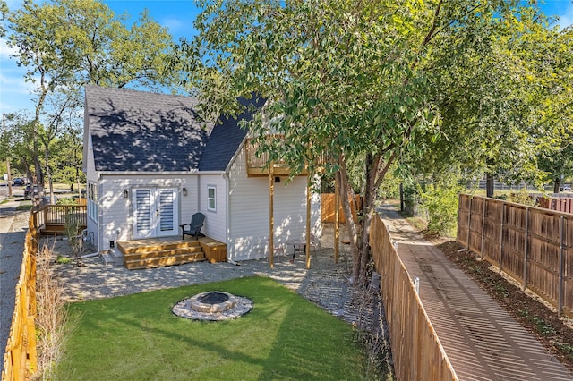 view of yard featuring a fire pit and a wooden deck