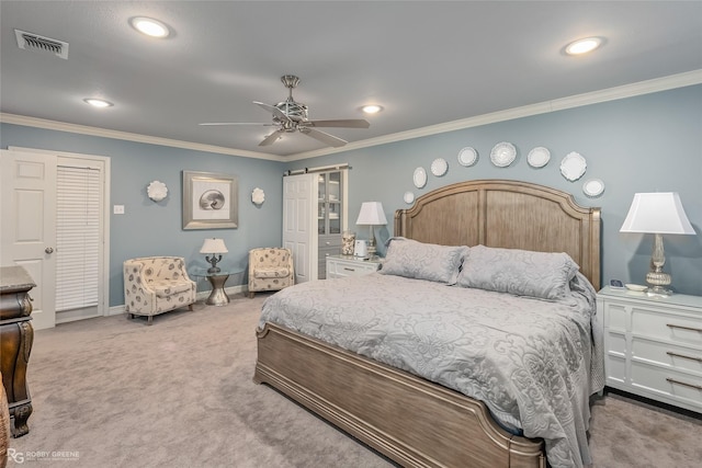 carpeted bedroom featuring ceiling fan, crown molding, and a barn door