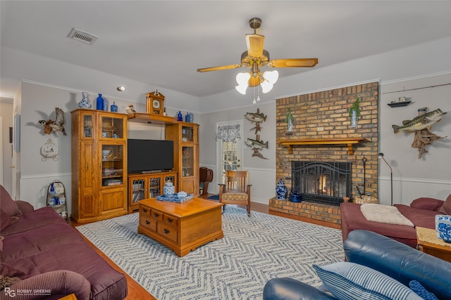 living room featuring ceiling fan and a fireplace