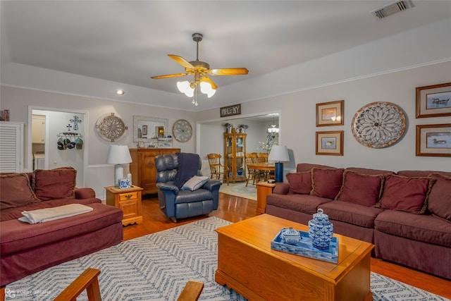 living room with ceiling fan and light hardwood / wood-style floors