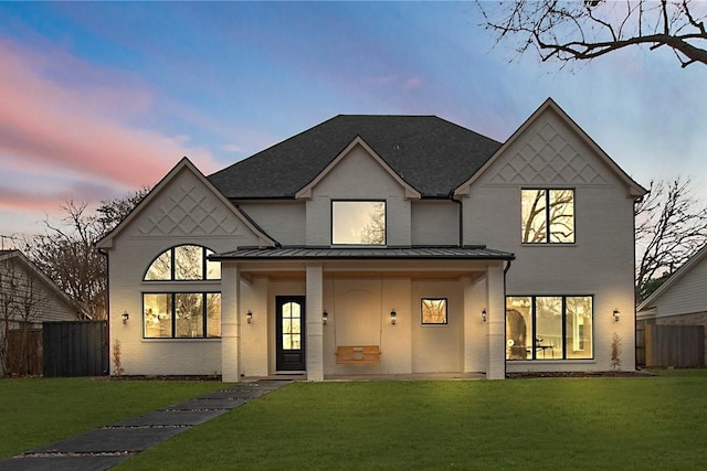 view of front of property with a lawn and a porch