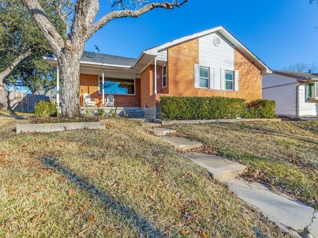 ranch-style house featuring a porch and a front lawn