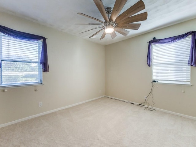 carpeted spare room with ceiling fan