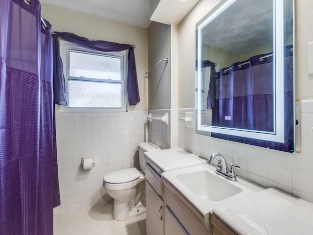 bathroom featuring a shower with shower curtain, vanity, tile walls, tile patterned flooring, and toilet