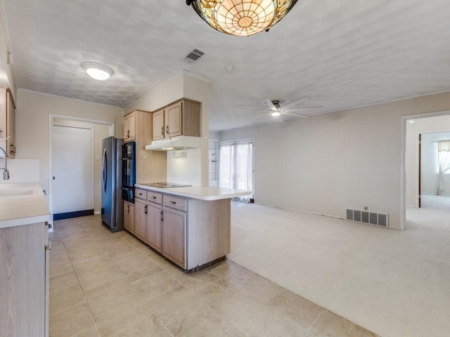 kitchen with light carpet, stainless steel fridge, kitchen peninsula, ceiling fan, and sink