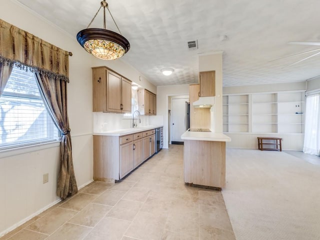 kitchen featuring sink, stainless steel appliances, hanging light fixtures, built in features, and light colored carpet