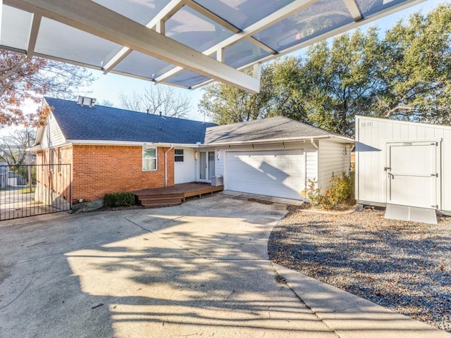 view of front of property with a garage and a storage unit