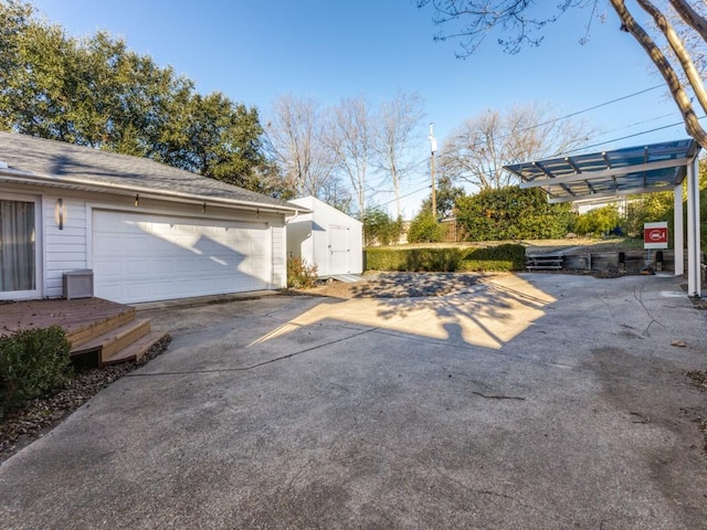 view of home's exterior with a garage and a storage unit