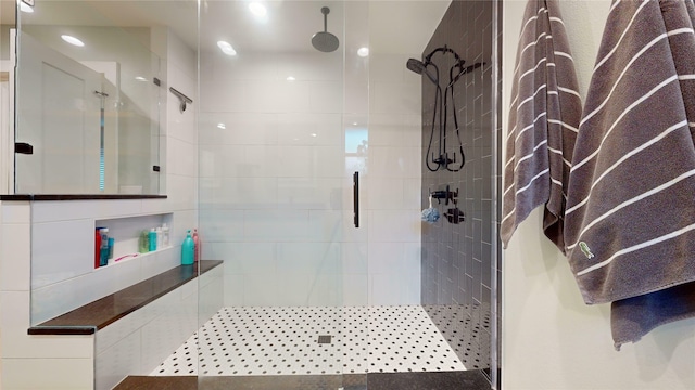 bathroom featuring a shower with shower door