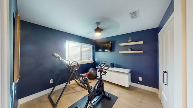 workout area with light wood-type flooring and ceiling fan