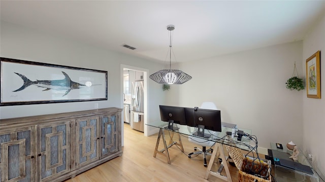 office area with light hardwood / wood-style floors