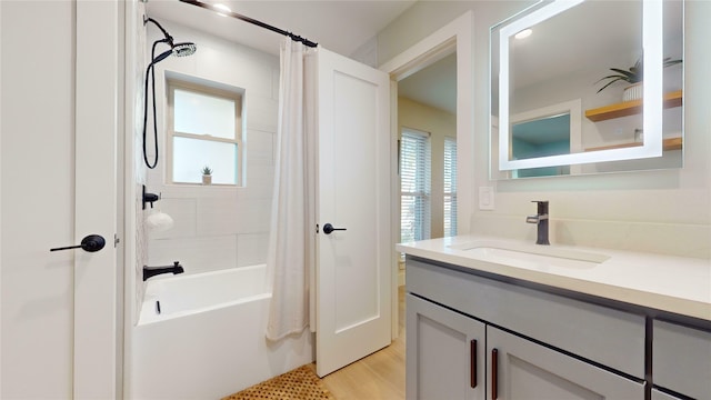 bathroom featuring shower / bath combo, vanity, hardwood / wood-style flooring, and a healthy amount of sunlight