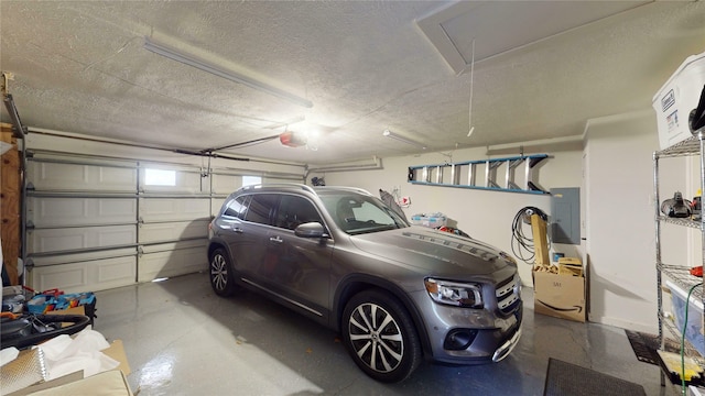 garage featuring electric panel and a garage door opener