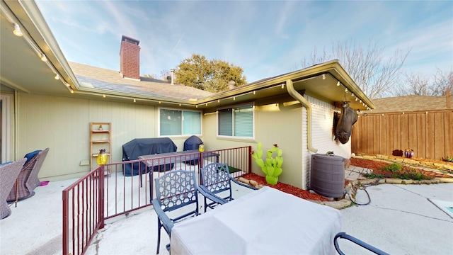 view of patio with a grill and a balcony