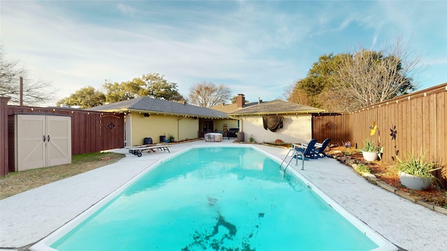 view of swimming pool featuring a storage shed