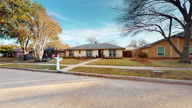 ranch-style house with a front lawn