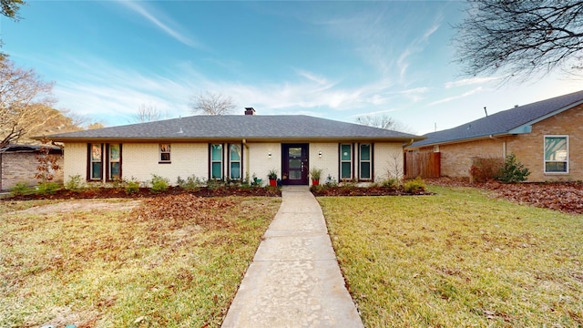 ranch-style house with a front lawn